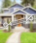 M6 Eye And Eye Turnbuckle Built Tough Adjustable Cable Tensioner Hella Durable Rigging End Fitting Secure Lock Steel Hardware For Marine Automotive Projects Ready To Roll in focus with blurred house background.