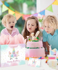 Children celebrating with a 13 Inch Unicorn Birthday Gift Bag With Card And Tissue Paper For Baby Girls And Kids Birthday Bash