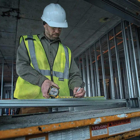 Construction worker using NGT 25 Foot Tape Measure With One And A Quarter Inch Tape For Quick Accurate Measurements Durable Locking Mechanism