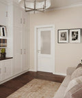 Modern living room with white cabinets, framed art on wall, and neutral decor featuring soft colors, plants, and hardwood floors.