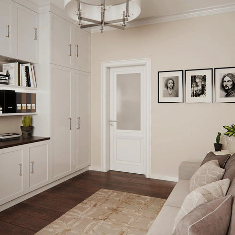 Modern living room with white cabinets, framed art on wall, and neutral decor featuring soft colors, plants, and hardwood floors.