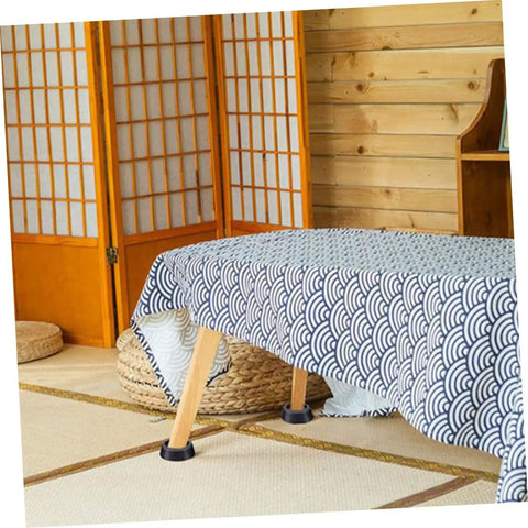 Anti Slip Washing Machine Foot Pads Set For Stability And Quiet Vibration Control under table in room with wooden decor.
