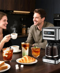 Programmable 12 Cup Coffee Maker With Four Brew Strength Options Hot And Iced Coffee Large LED Display 24 Hour Timer Keep Warm And Auto Shutoff Black And Stainless Steel Drip Coffee Machine For Home Or Office on kitchen counter with breakfast items.