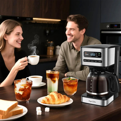 Programmable 12 Cup Coffee Maker With Four Brew Strength Options Hot And Iced Coffee Large LED Display 24 Hour Timer Keep Warm And Auto Shutoff Black And Stainless Steel Drip Coffee Machine For Home Or Office on kitchen counter with breakfast items.