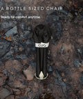 Go To Ultra Lightweight Camping Chair For Outdoors Easy Fold Portable Lawn Chair folded to bottle size on rocky ground