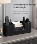 PU Leather Desk Organizer And Pen Holder For Office Black on bedside table with remote, notebooks, pens neatly sorted.