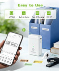 Slick Portable Bluetooth Label Maker With Included Tape, Compact Mini Label Printer shown with smartphone and labels for organization.