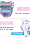 Close-up of pink all-in-one kid protective gear wrist guard with rainbow elastic band and perforated soft fabric.