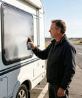 Man applying Glass Frosting Spray 30ml Portable Anti-Glare Privacy Liquid on RV window for privacy.