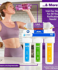 Woman drinking water next to a Three Stage Whole House Water Filter System Replacement Cartridge Pack For Clean, Safe Water Across Your Whole Home - Includes 3 High-Quality Cartridges, Easy Install, White.