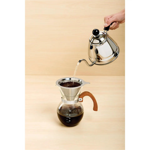 Next Level Pour Over Coffee Maker With Heat Resistant Borosilicate Glass Carafe And Comfortable Bamboo Handle Plus Durable Stainless Steel Filter pouring hot water over coffee grounds.