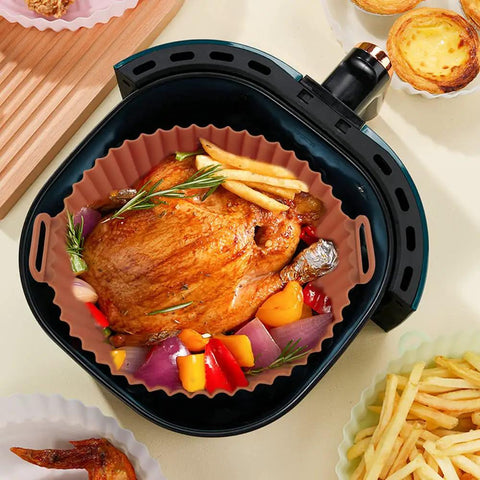 Chicken and vegetables inside Two Pack 8 Inch Square Air Fryer Silicone Liners Non Stick Reusable Parchment Alternative Easy Cleanup