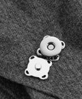15mm silver Plum Magnetic Snap Closures for purses on gray fabric