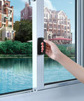 Hand using 6 Pack Self Stick Cabinet Handles And Drawer Pulls With Adhesive on a glass window, showcasing drill free installation