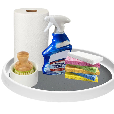 Set Of Two 12 Inch Non Skid Lazy Susan Organizer Smooth Spinning Turntable For Pantry Cabinet Kitchen Storage Game Changer With Super Grippy Rubber Base And Ball Bearings with cleaning supplies and sponges on a white platform.
