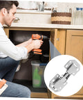 Man installing concealed cabinet hinges for wardrobe using a drill.