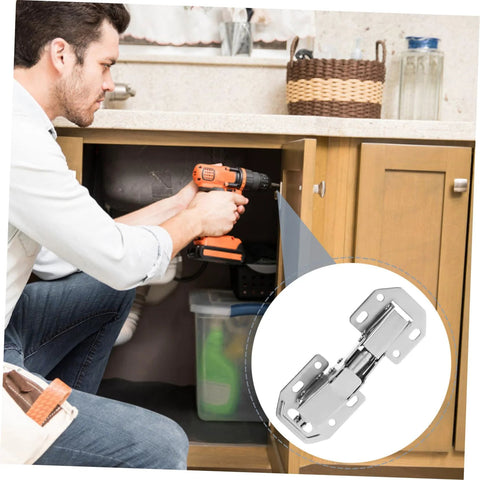 Man installing concealed cabinet hinges for wardrobe using a drill.