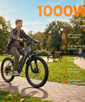Cyclist on Adult Electric Bike 24 Inch Frame With 1000W Peak Motor And 504Wh Battery, cruising in park, front suspension visible