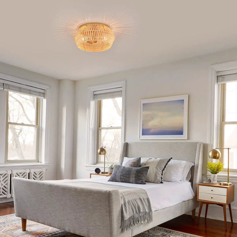 Natural Rattan Flush Mount Ceiling Light Fixture in Antique Brass Brush Finish illuminating a modern bedroom with rustic bamboo shade.