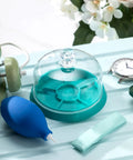 3 Piece Watch Cleaning Kit With Putty Movement Dust Cover And Air Blaster on table with watch and green box