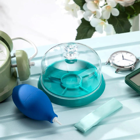 3 Piece Watch Cleaning Kit With Putty Movement Dust Cover And Air Blaster on table with watch and green box