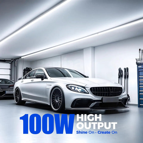 High Output 100W 15000LM 6500K T8 LED Shop Light Strip, 8Ft in a modern garage, illuminating cars with bright daylight