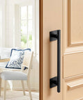 Rustic Barn Door Handle 12.6 Inch Built Tough for All Weather Gates Heavy Duty Carbon Steel Pull With Rust Resistant Coating Easy Install Sliding Door Handle for Garage Shed Closet Pantry Black Finish on a wooden door in a sunny room.