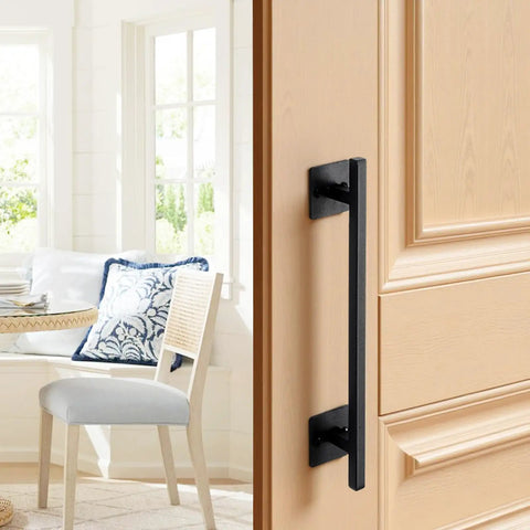 Rustic Barn Door Handle 12.6 Inch Built Tough for All Weather Gates Heavy Duty Carbon Steel Pull With Rust Resistant Coating Easy Install Sliding Door Handle for Garage Shed Closet Pantry Black Finish on a wooden door in a sunny room.