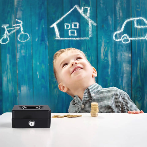 Child smiling at a Compact Cash Box With Slot And Key Lock Portable Metal Money Safe with coins on the table