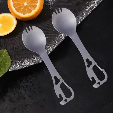 Two 5 In 1 Stainless Steel Spork Fork Spoon Combo with Can Bottle Opener on a dark background next to orange slices.