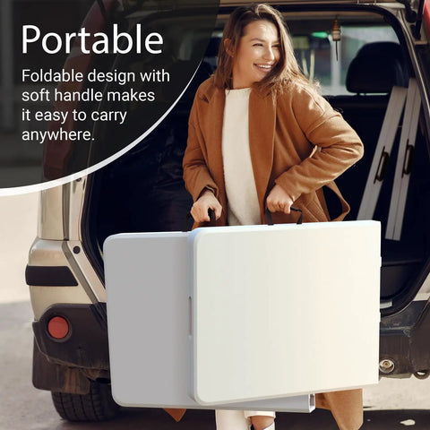 Woman carrying 6 foot foldable table with built in handle and steel legs, heavy duty portable utility table party ready