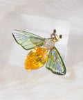 Vintage Crystal Bee Brooch For Women Featuring Amber And Clear Rhinestone Bumblebee Wings on soft fabric background.