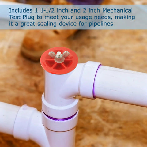 Close-up of red mechanical end-of-pipe gripper plug atop white PVC pipe joint (2 in and 1-1/2 in).