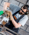Man using power saw wearing Bulk 100 Safety Glasses Set For Men And Women Eye Protection Goggles With Scratch Resistant And Impact Resistant Lenses Ideal For Work Construction Lab Science Outdoors Dark Black