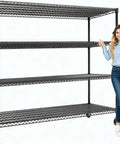 Tough As Nails 4 Tier Metal Wire Shelving Rack With Smooth Rolling Casters And Rust Resistant Matte Black Finish beside a woman.