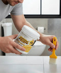 Hand applying Heavy Duty Roof Sealant Waterproof Invisible Coating for sealing leaks on a tiled surface.