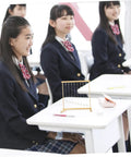 Students observing Snake Shape Pendulum Energy Conservation Model Kit For DIY Science Projects on classroom desk