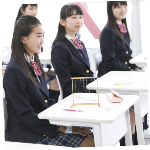 Students observing Snake Shape Pendulum Energy Conservation Model Kit For DIY Science Projects on classroom desk