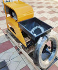 Heavy Duty Portable Construction Mortar Spraying Machine on wooden pallet, showcasing yellow body, mixing hopper, and large wheel.