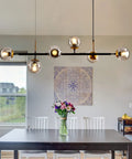 Mid-Century Glass Globe Pendant Light Fixture In Black And Gold over dining table