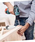 Man using a drill to install Smooth As Butter Sliding Door Rollers Straight Up Sturdy Barn Door Wheels Heavy Duty Galvanized Nylon Casters.