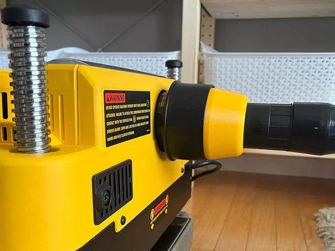 Close-up of a two and a half inch hose adapter for planer dust port fits 735 and 735X, showing quick friction fit connection.