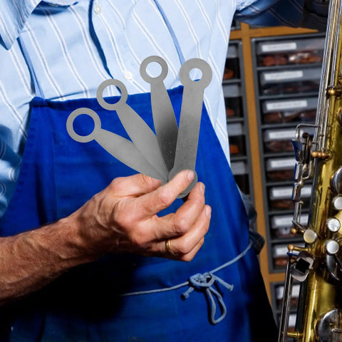 Hardcore Rock Solid Hella Reliable Saxophone Repair Toolkit And Kickass Woodwind Setup Pads With Heavy Duty Metal Adjustment Screws For Professional Clarinet And Sax Fixes In Studio - silver metal tools in hand.