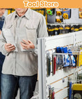 Tool store interior with display of various tools and accessories on slatwall panels.