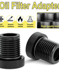 Two black metal thread adapters for 1/2-28 to 3/4-16 with rubber washers, knurled ends for automotive use