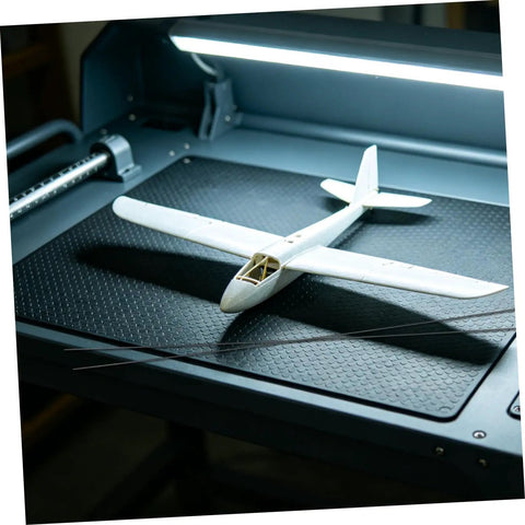 Beefy Carbon Fiber Rods 1.64 ft Long 0.08 in Diameter, 10 Pack with Model Aircraft on Workbench
