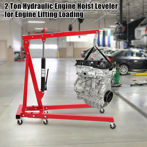Heavy Duty Hydraulic Engine Hoist With Telescopic Boom And 6 Roll Smooth Casters, 4400 Lb Folding Cherry Picker in a workshop with engine lifted.
