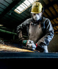 Worker using 9-Inch Angle Grinder With Lock-On Trigger, 6600 RPM, 15 Amp, W24-230 MVT for metalwork, sparks flying.