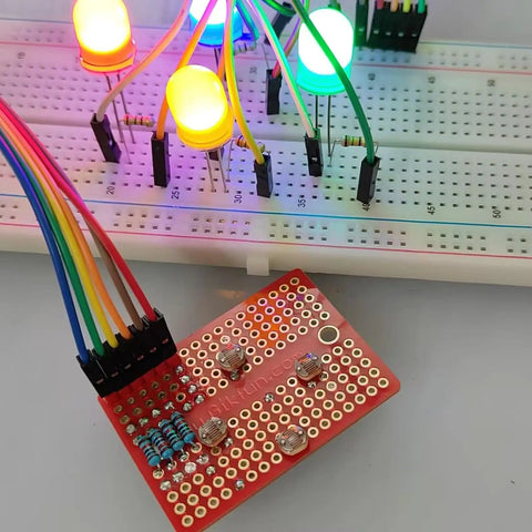 Mini solderable breadboard with gold plated finish proto board for Arduino and DIY electronics, connected to LEDs and wires