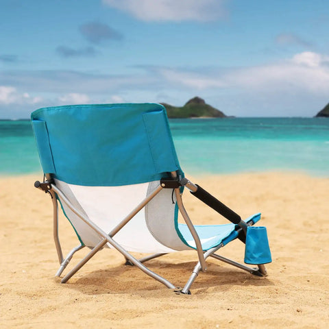 Low Beach Chair With Mesh Back And Cup Holder Foldable Camp Chair For Outdoor Use on sandy beach by the ocean